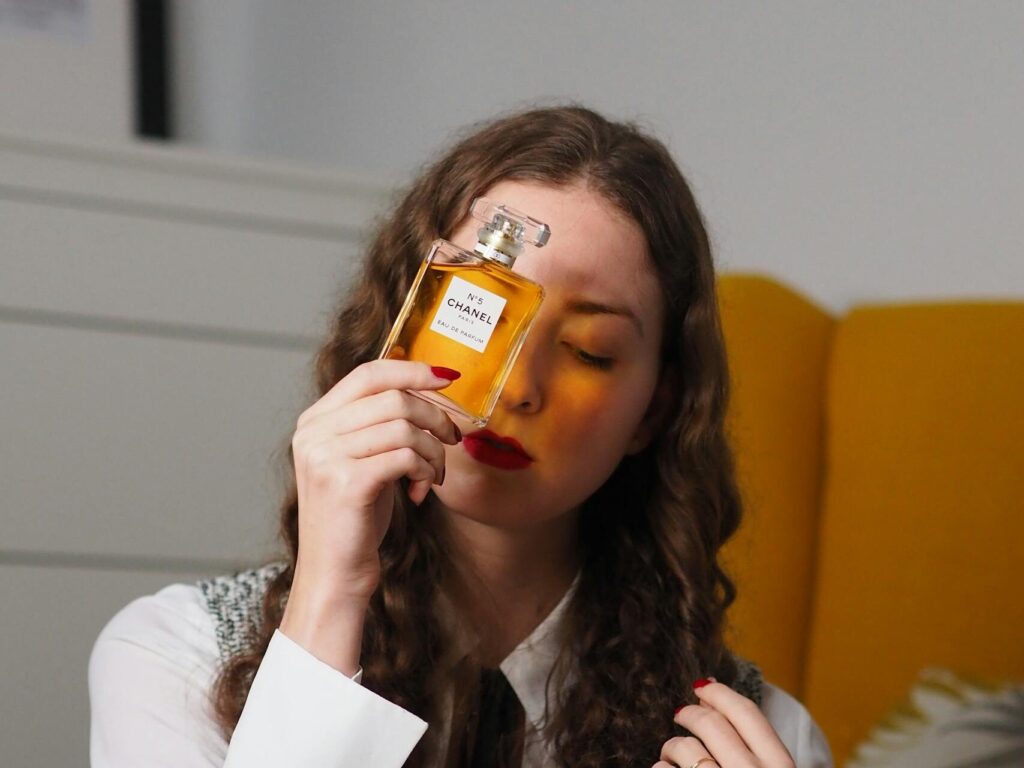 A woman is holding a bottle of whiskey